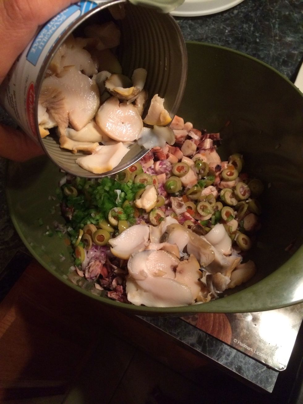 This step is totally optional. I added the scungilli next.  I chopped up the scungilli into pieces, since there was big chunks in the can.