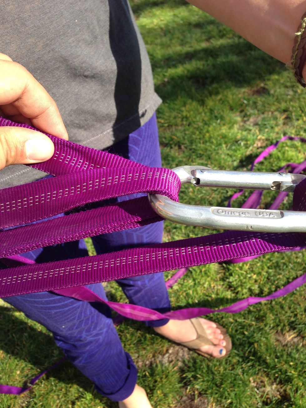 This step is tricky. Have the webbing from C4 go back through C2 from the bottom between C2 and the webbing already through the carabiner. This webbing friction is how the slackline holds tension.