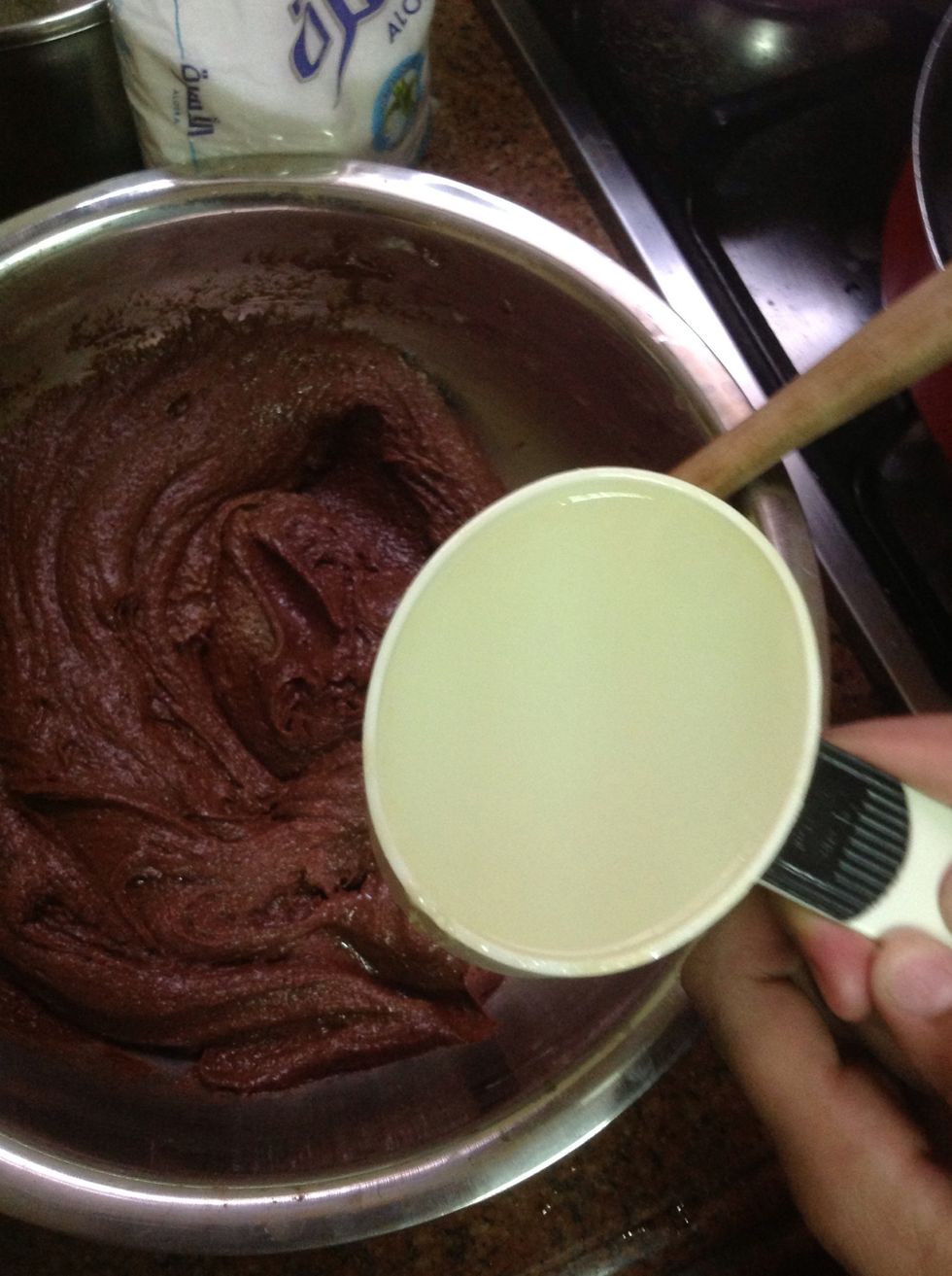 this step is tricky . you need to pour the hot water over it while you are whisking or mixing the mixture , so it wouldn't cook the eggs . you could use a processor to do that .