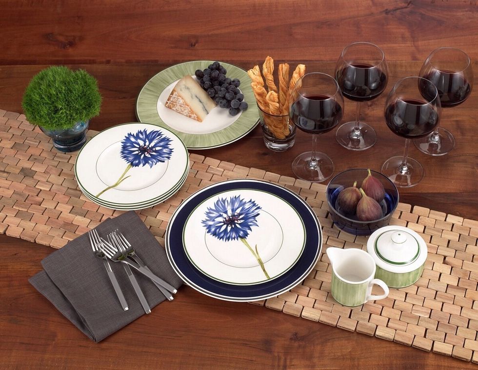 This table setting showcases the versatility of Villeroy & Boch Flora dinnerware. Navy blue chargers and darker linens make the spring cornflower appropriate for a winter dinner party.