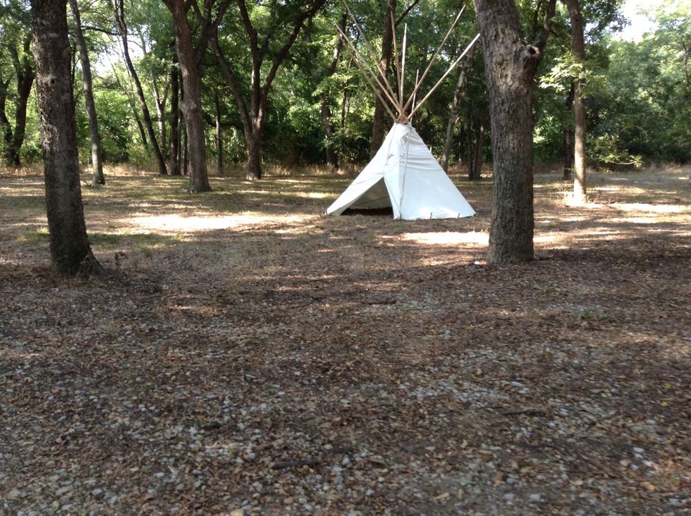 This tepee is made of strong cloth and large pieces of wood.