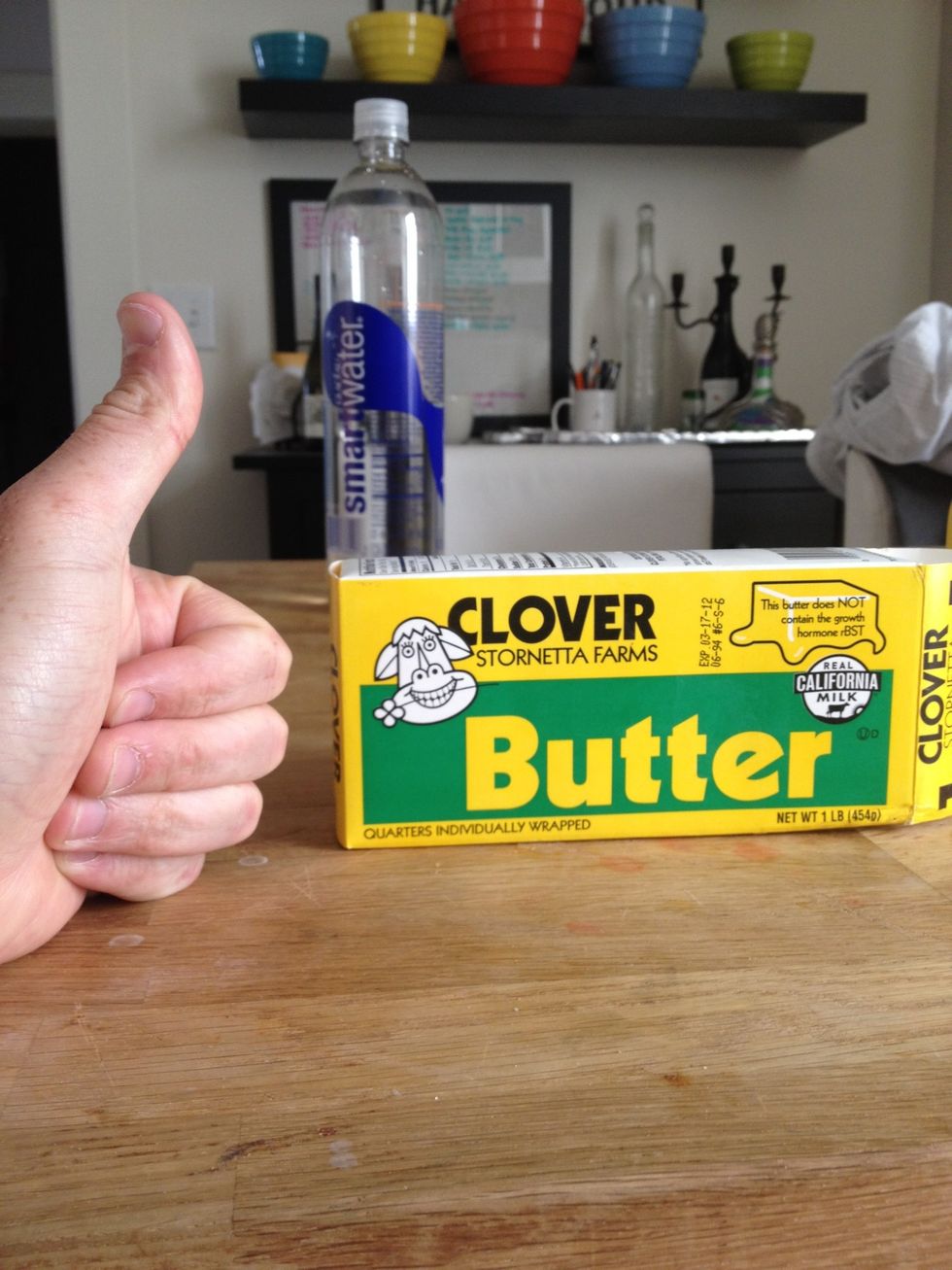 THIS. The real shit. Slice off a third of a stick and put it in a clear teacup-like object. Pop this in the microwave and heat for 25 seconds or until liquid. Now, it's butter time.