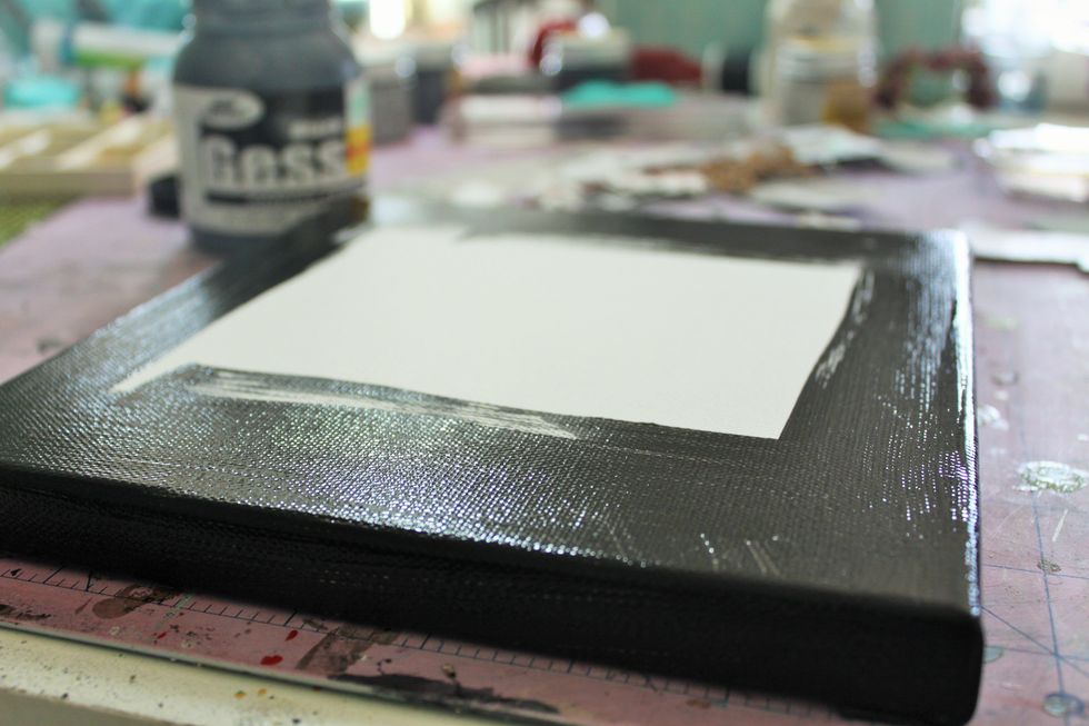 This time I decided to created an 8x8 canvas. Begin by painting the sides and about an inch in along all edges with black gesso.