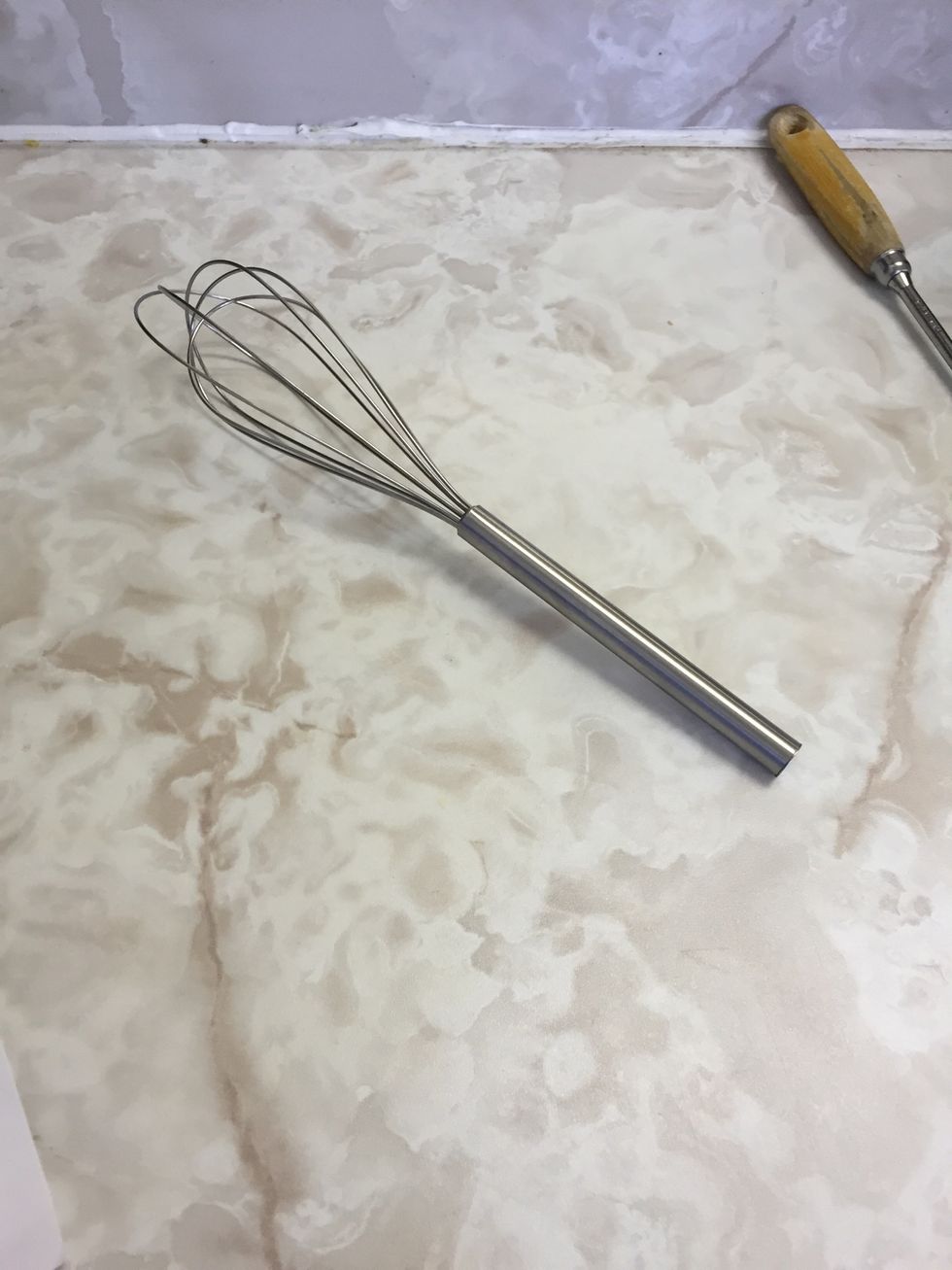 This tool is a whisk. You use a whisk when stirring food. I can use a whisk to stir eggs.