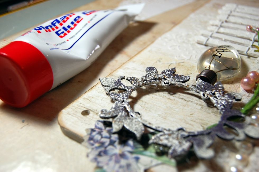 This type of glue also makes it very easy to add height and dimension. I added baubles of pinflair under my frame to lift it off the MDF base.