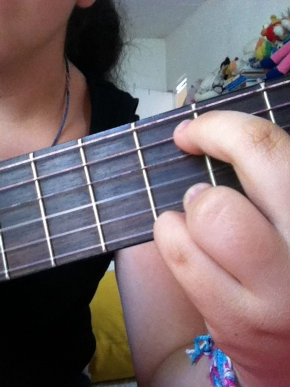 This way. This will be our first chord. To play it you'll do it this way: you play the 5th string and just after the 3rd, and repeat this.