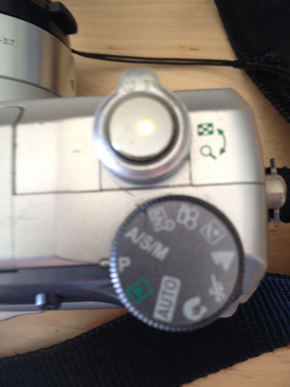 This wheel will change how the camera works. We want to leave it on the "P" setting