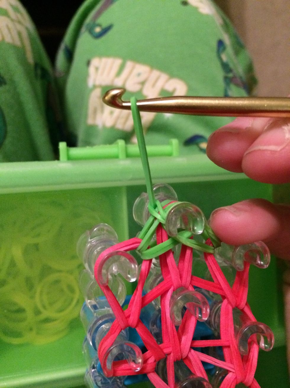 This will create a slip knot. The is what keeps your charm together. Holding all the rubber bands in place. Now it's time to pull it off the loom \ud83d\ude00