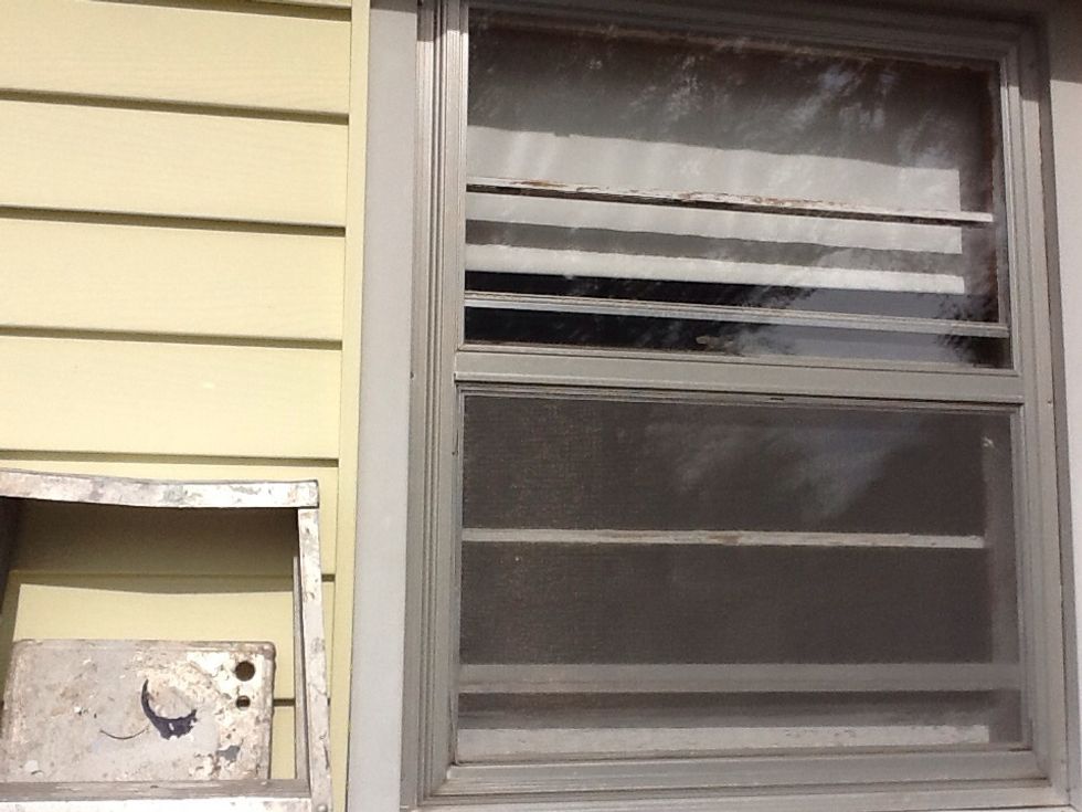 This window is a single pane and is covered by  an aluminum storm window. The first step is to remove the storm window so you have access to the single pane window.