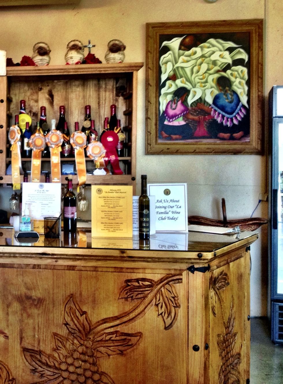 This winery's tasting room shows the Robledo family's Mexican heritage in the woodwork and decor as well as the artwork.