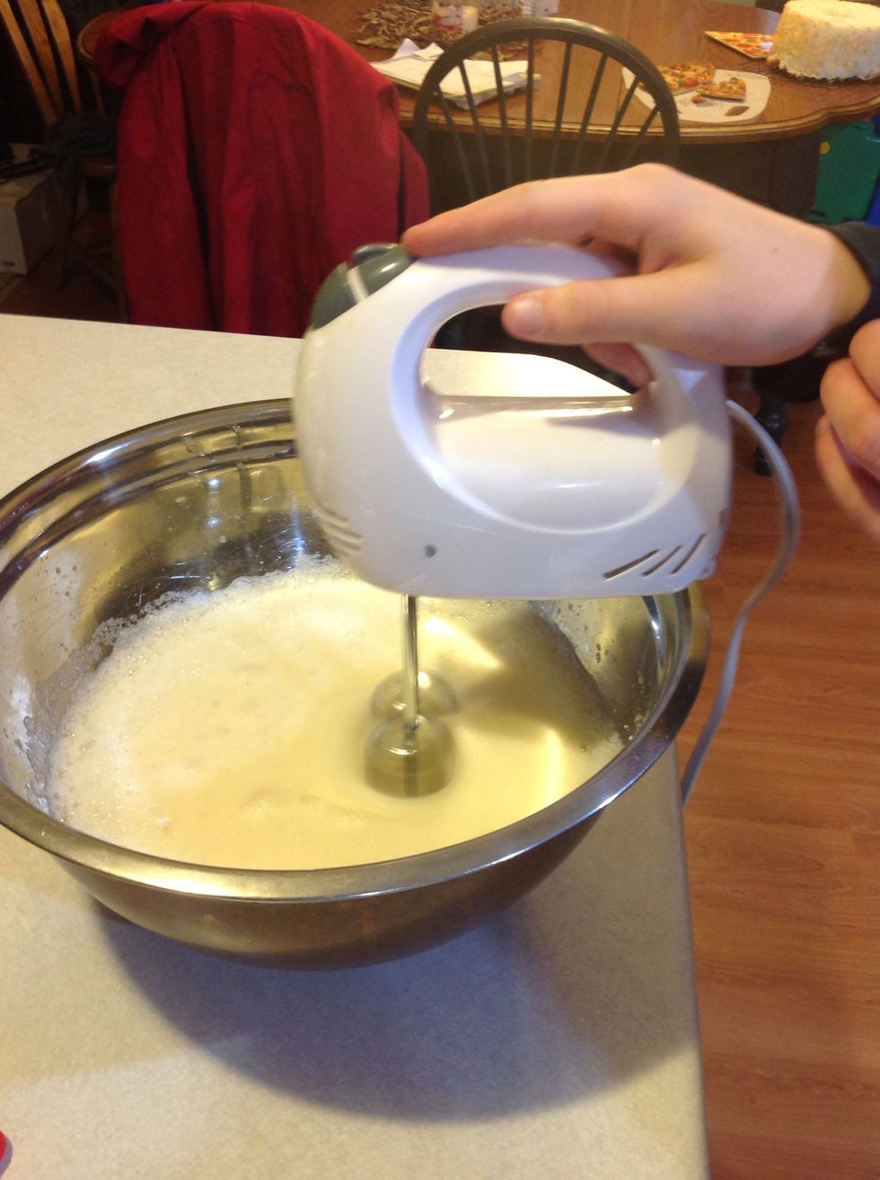 Thoroughly combine egg whites then add your water, extract and cream of tartar with a whisk for two minutes then use a hand mixer slowly add reserved sugar and beat until it forms half peaks.
