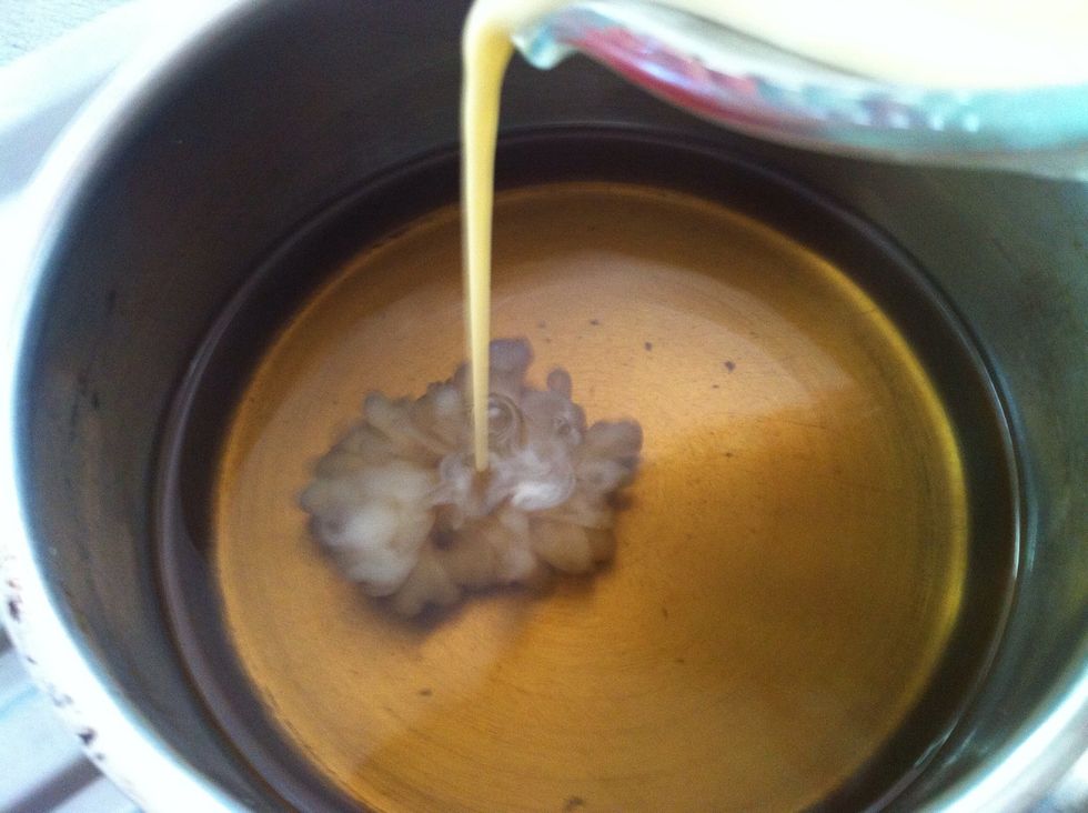 Thoroughly whisk eggs and evaporated milk together and then whisk in the sugar water and vanilla.