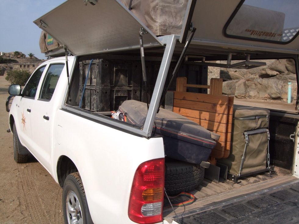 Those black boxes contain camping stuff, below you'll find a s cooker & chairs.