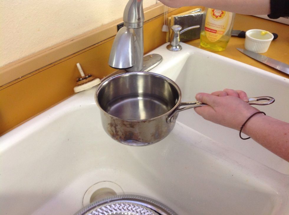 Thou will be making a double boiler. First you will fill the small sauce pot with about 1-2 inches of water.