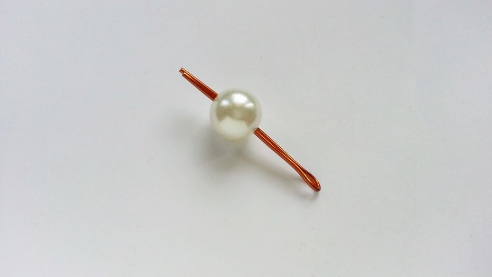 Thread a bead into the open ends of the bent wire.