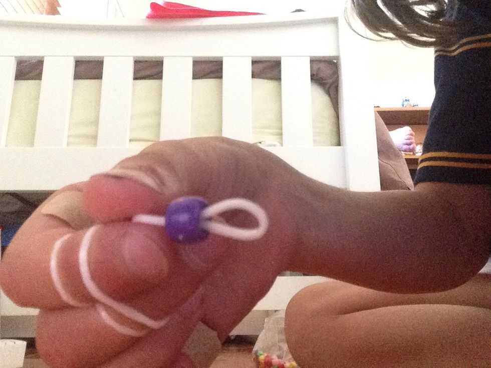 Thread a pony bead on to a band.