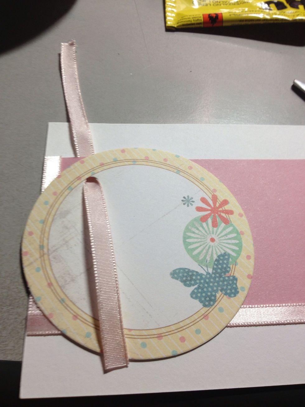 Thread a ribbon through both holes. The ribbon I used ended up being too short, you might want to use a longer piece.