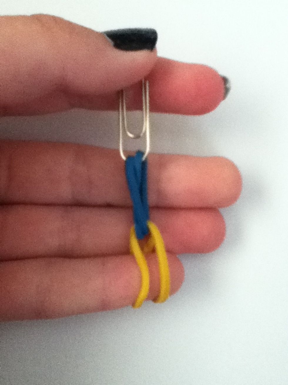 Thread another rubber band through the first one and pull it tight.