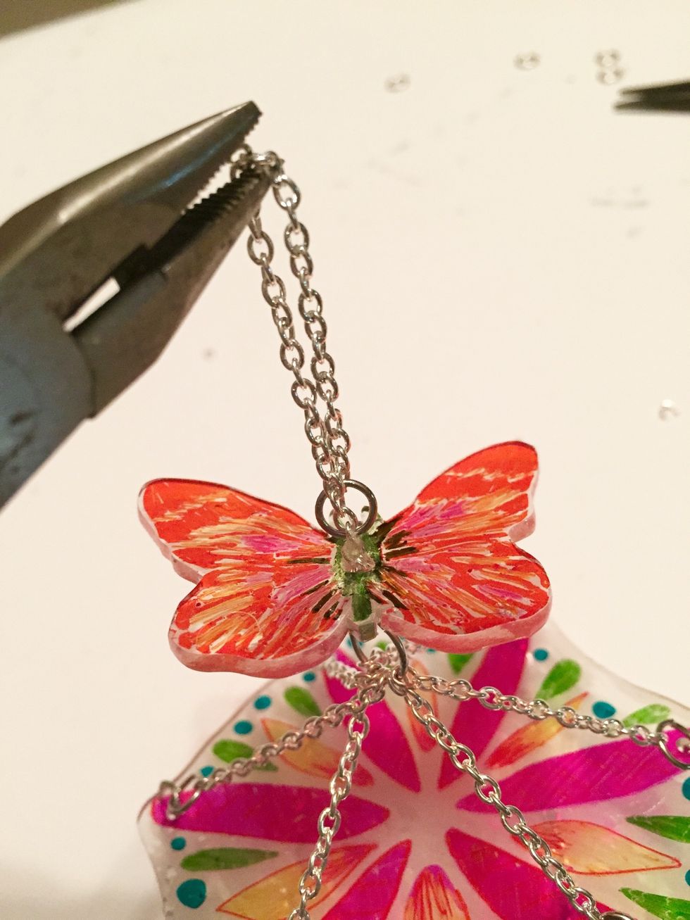 thread chain at base of loop down through butterfly and secure to large loop underneath.