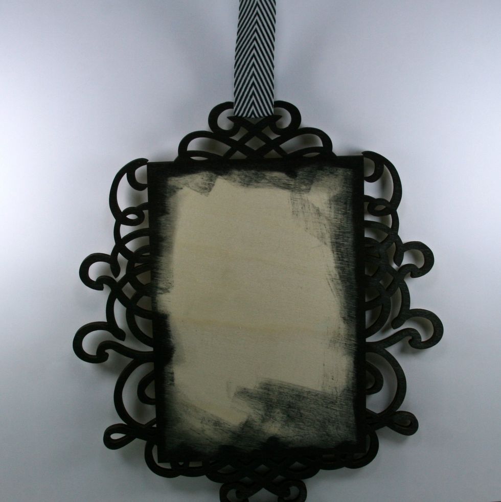 Thread chevron ribbon through top scroll to create a hanger. I secured mine with hot glue on the back.