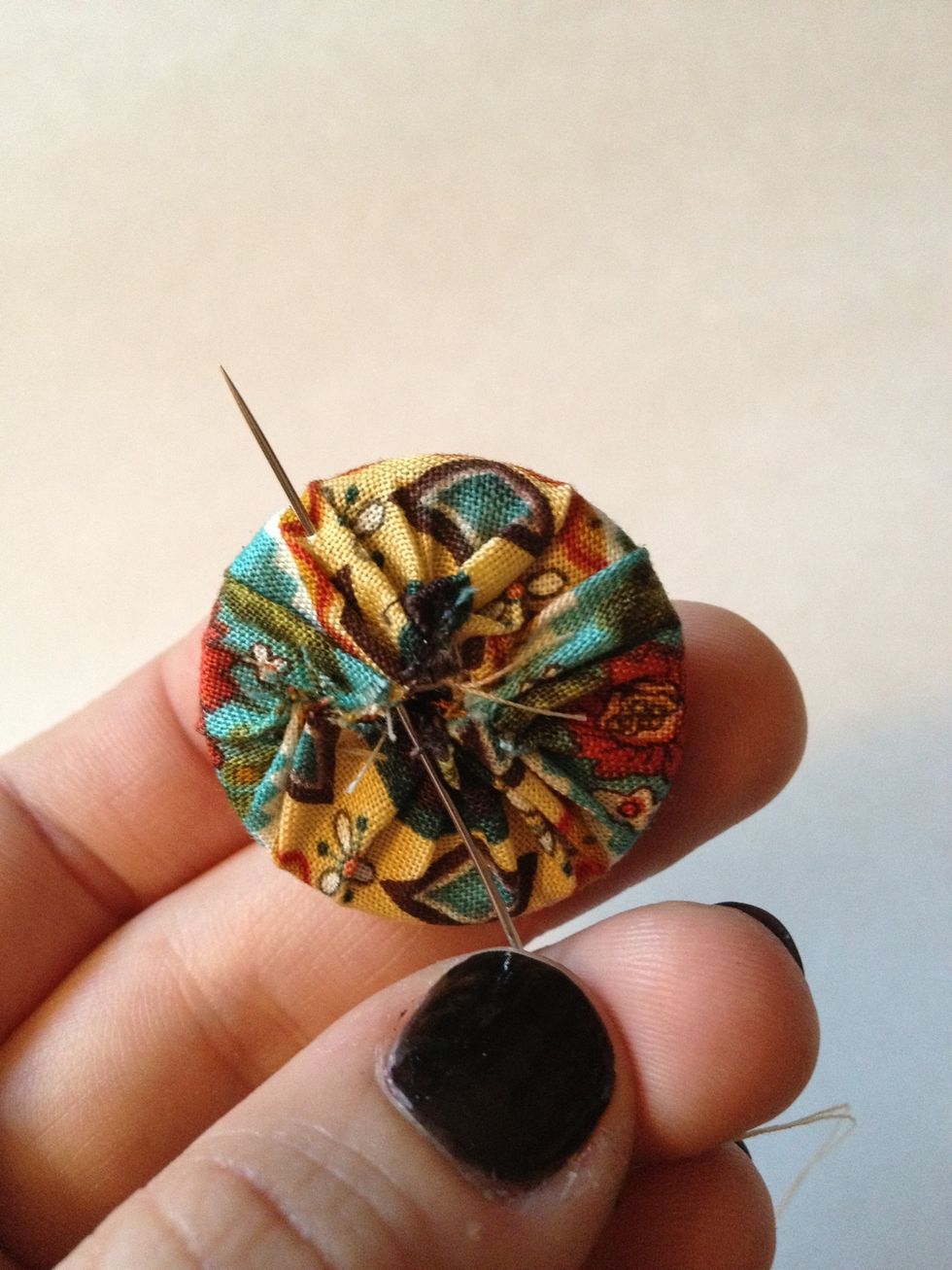 Thread needle and knot end. Enter fabric from underneath, coming up about 1/4" from the edge.