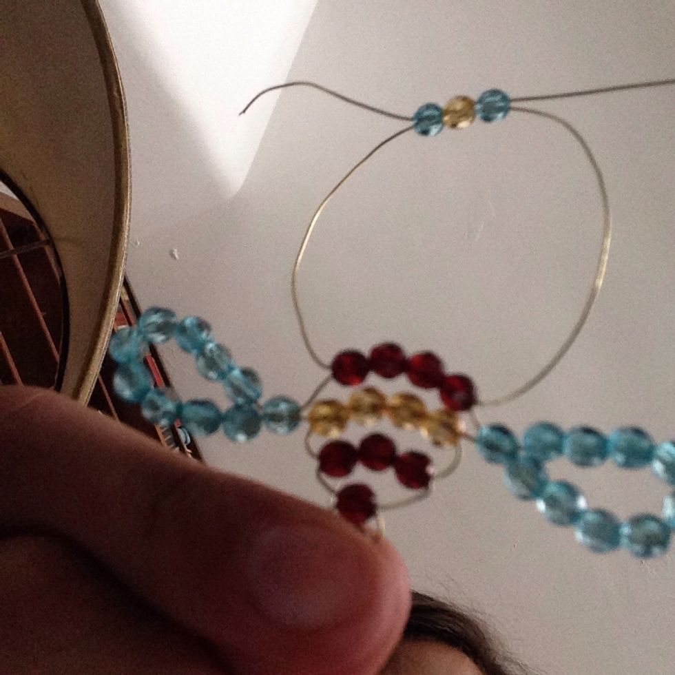 Thread one blue,one black and another blue bead for the eyes
