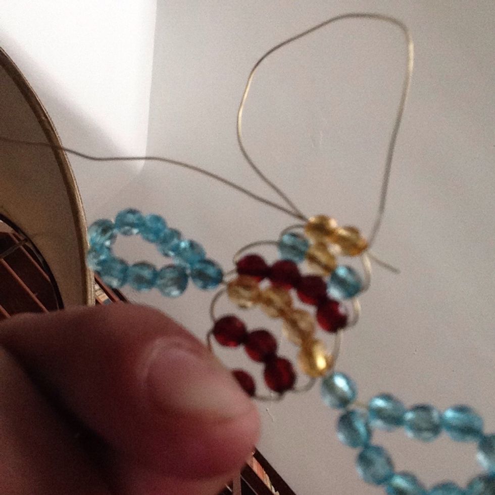 Thread one of the wires threw these two beads