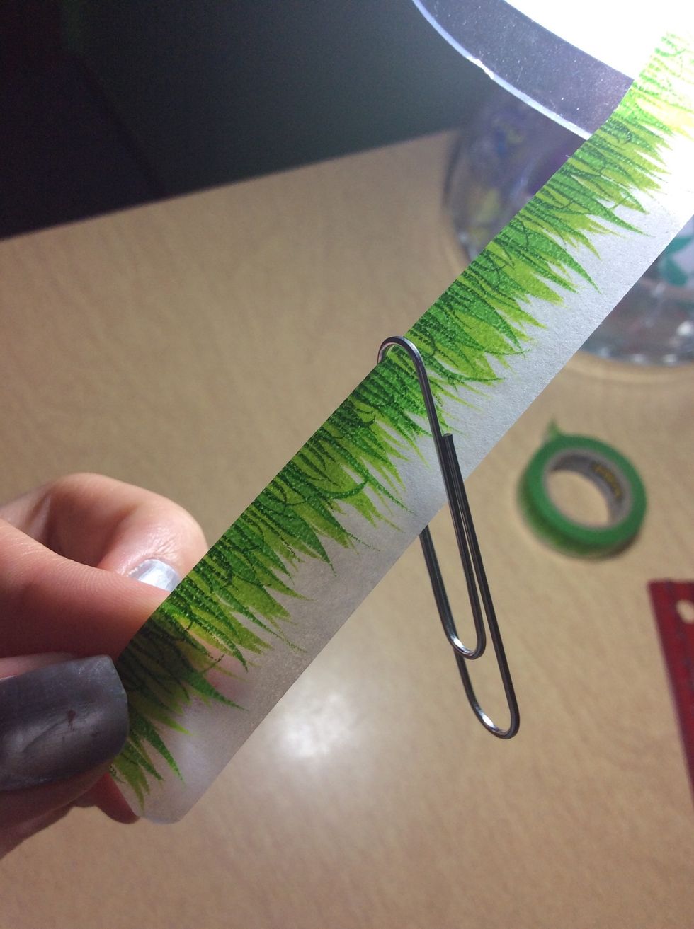 Thread paperclip onto the washi tape. In about the middle.