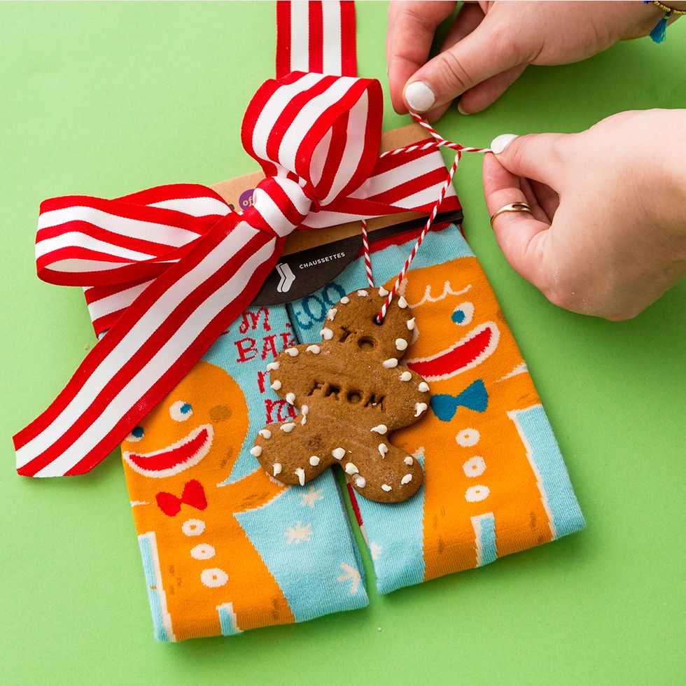 Thread ribbon or baker\u2019s twine through the hole and attach to your gifts, like these So Baked Gingerbread Man Toe of a Kind Sock. Look how cute they are! http://bit.ly/2gAMIGM