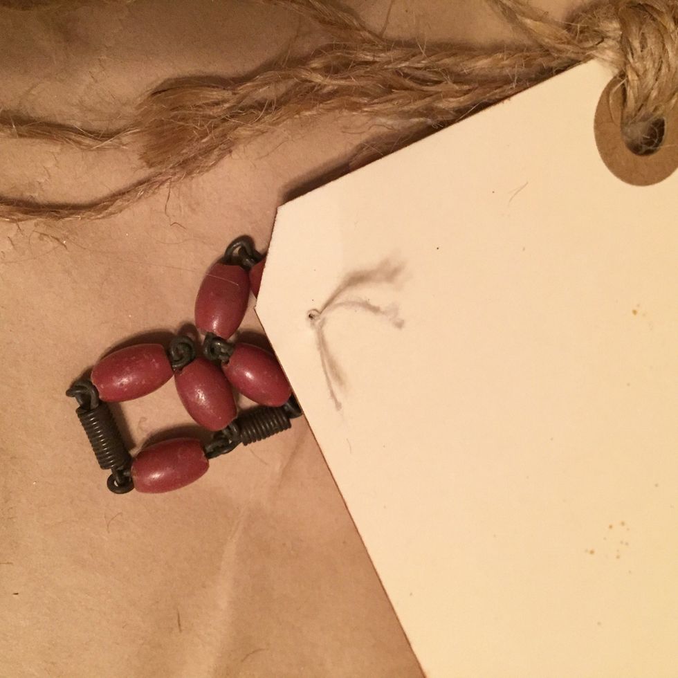 thread string up to front, tie on chain, then thread to back and knot. make knot large enough so that it will not pull through