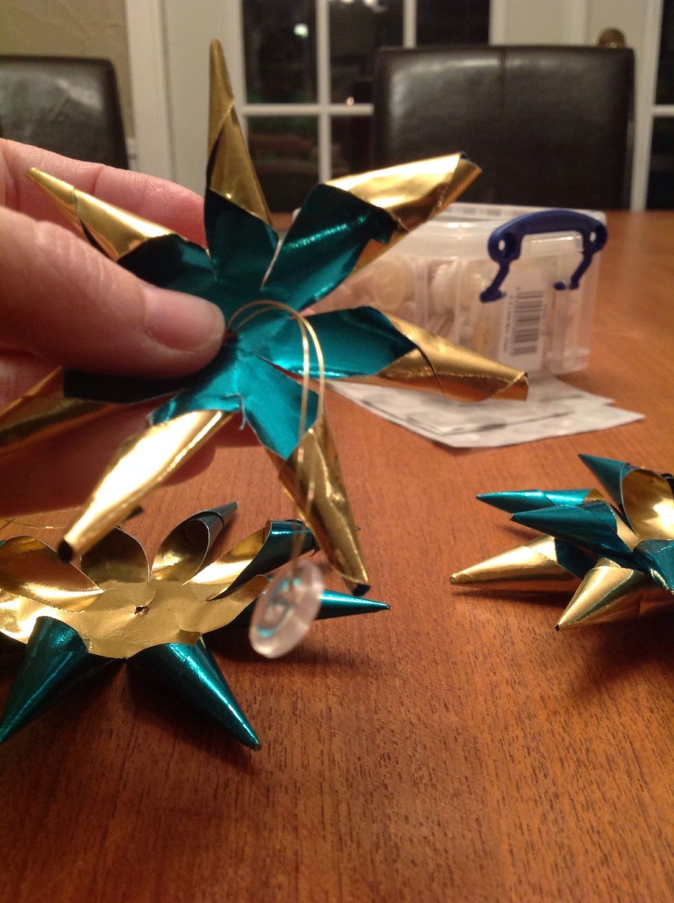 Thread the button and wire through the smallest star.