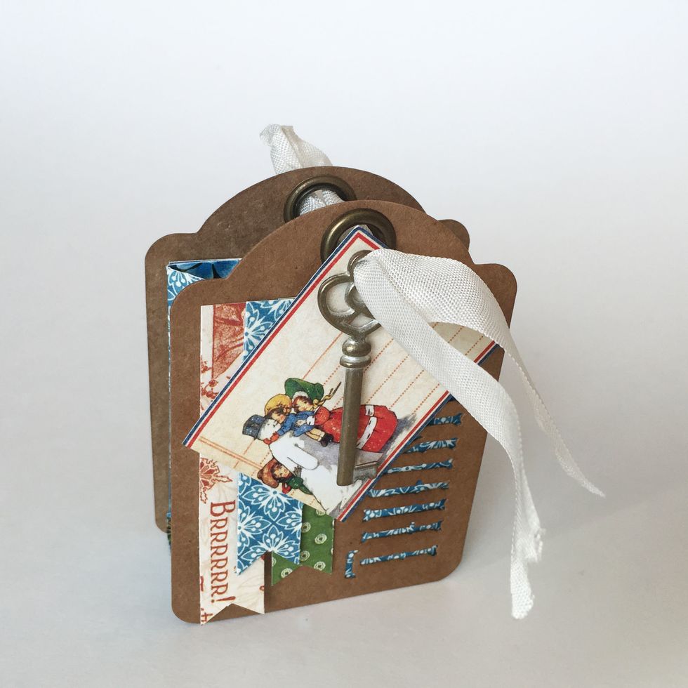 Thread the folded end of the seam binding through the holes of each \u2018Thanks\u2019 tag.