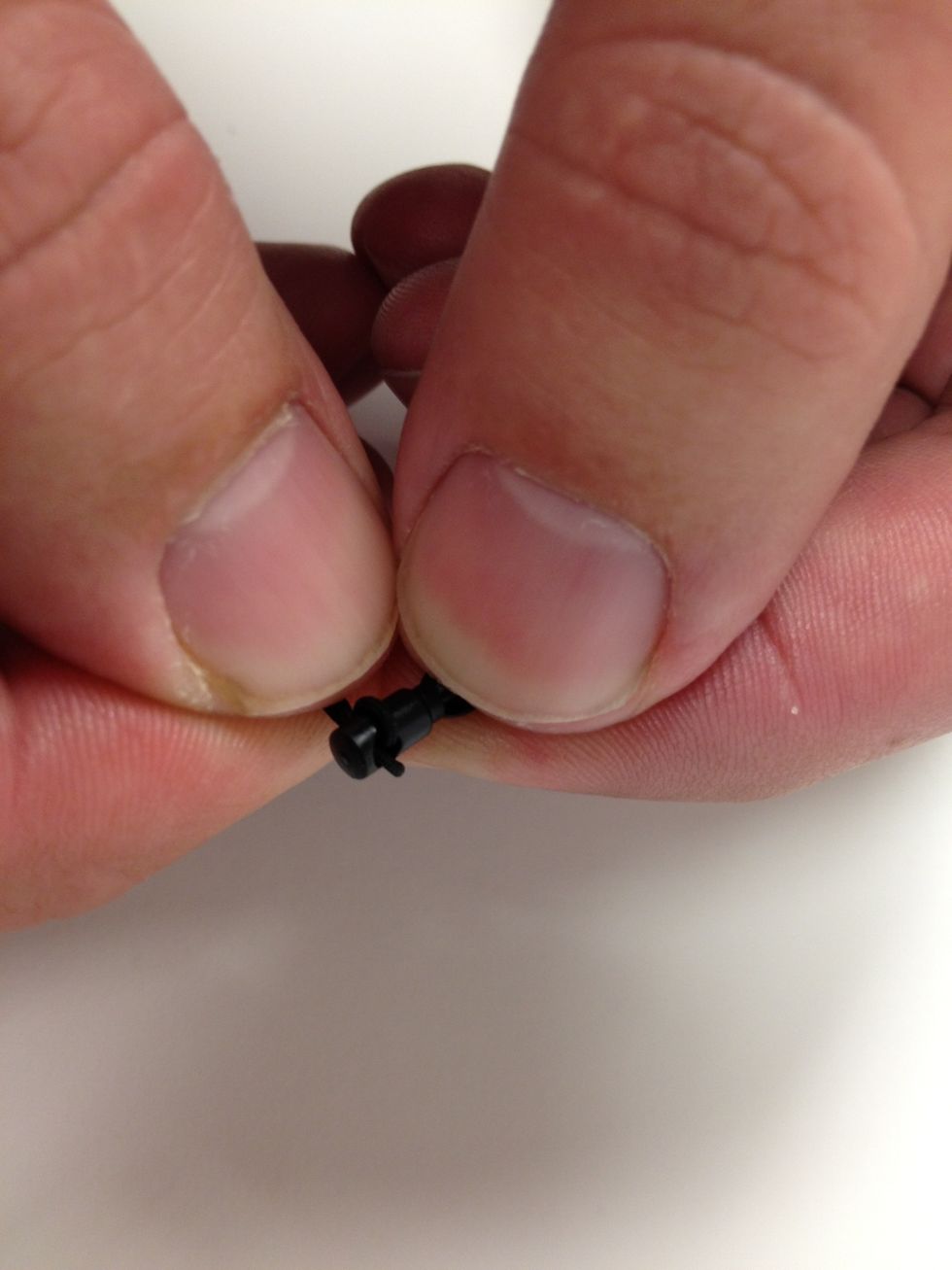 Thread the string from the cap into the plastic plug included with your Kuel Stylus Pen. Loop it around so it holds tight. Charles kept saying "like a lasso, like a lasso".