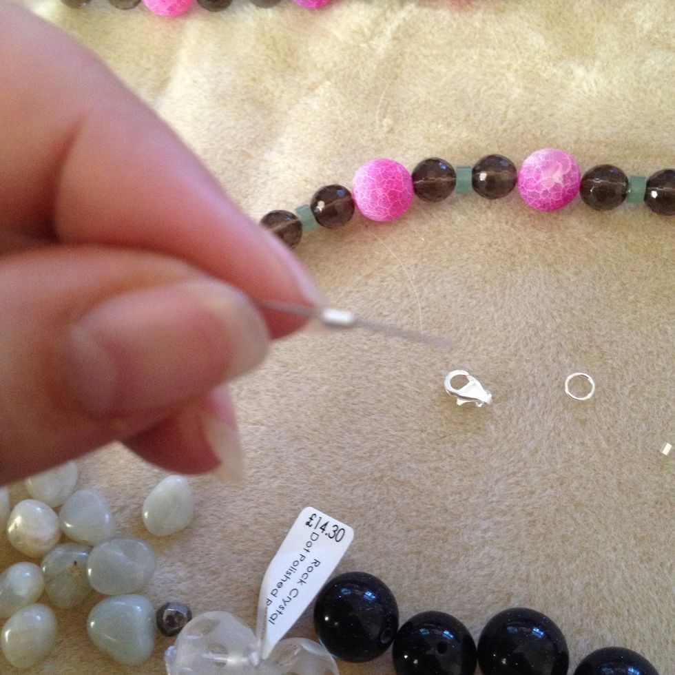 Thread the tiny clasp finding onto the wire like this