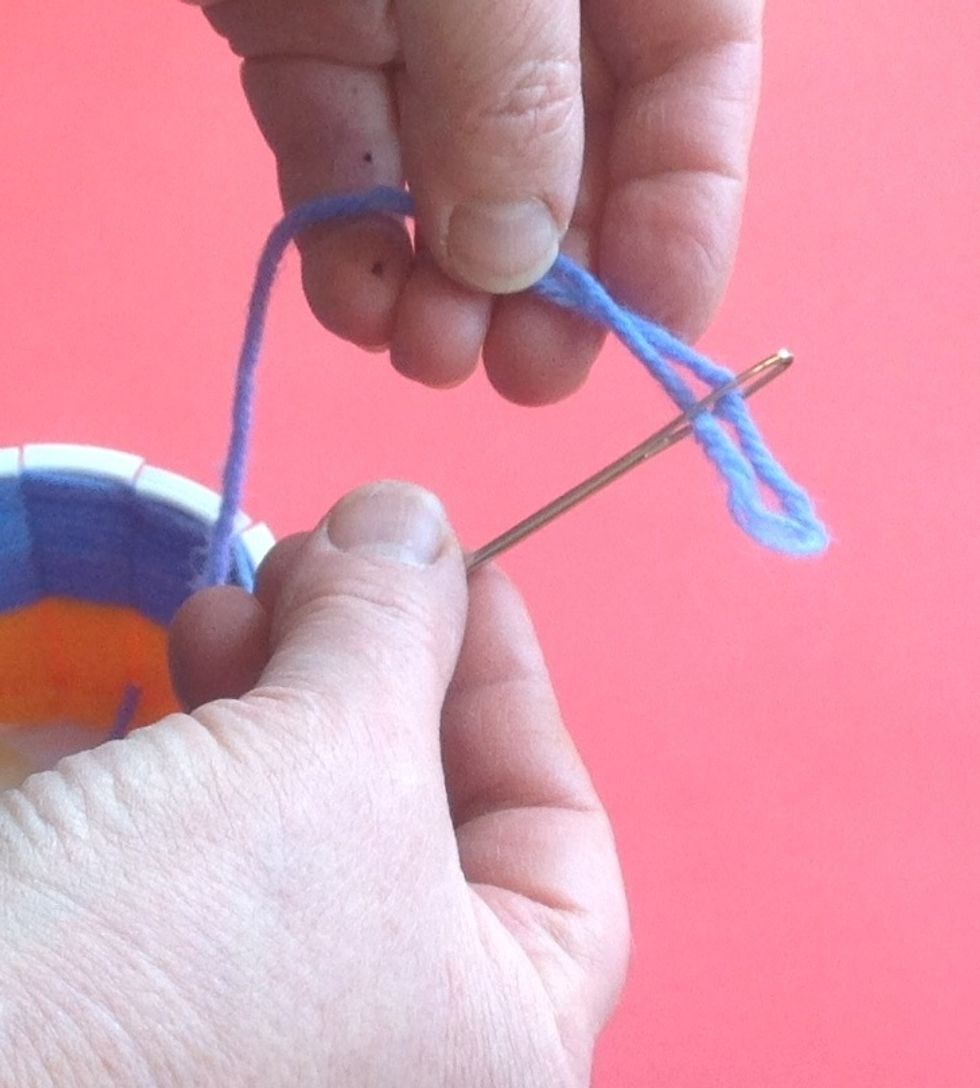 Thread the yarn onto the needle by pinching a loop of yarn and pulling it through - DO NOT TIE THE YARN TO THE NEEDLE.