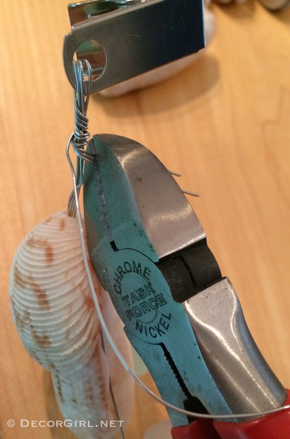 Thread three sea glass wires through top shell and through the hole in the pinch clip and twist to finish.  Snip 3 shorter wires, wrap with longer wire and thread down through top shell to hide.