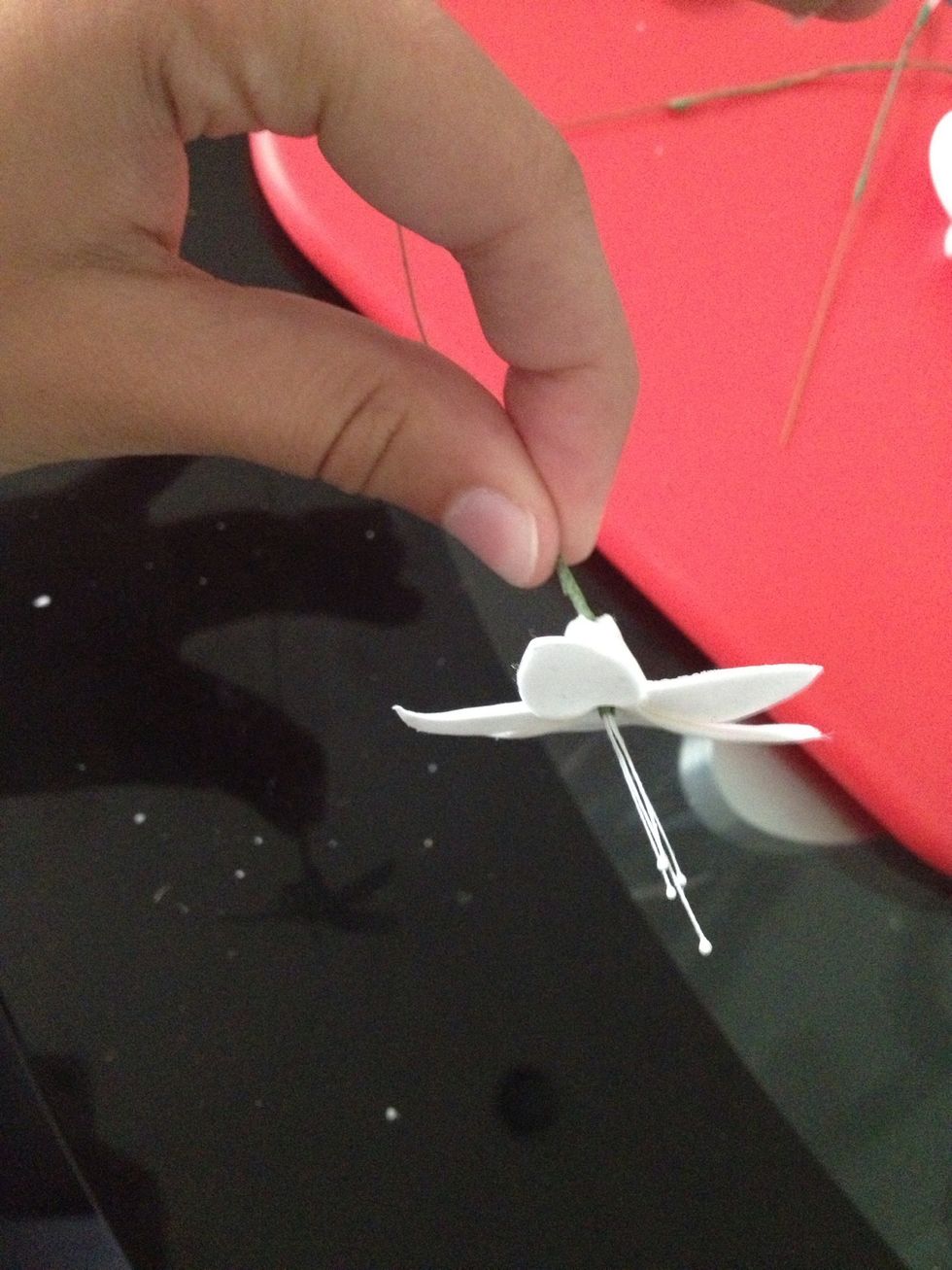 Thread through onto the stamen