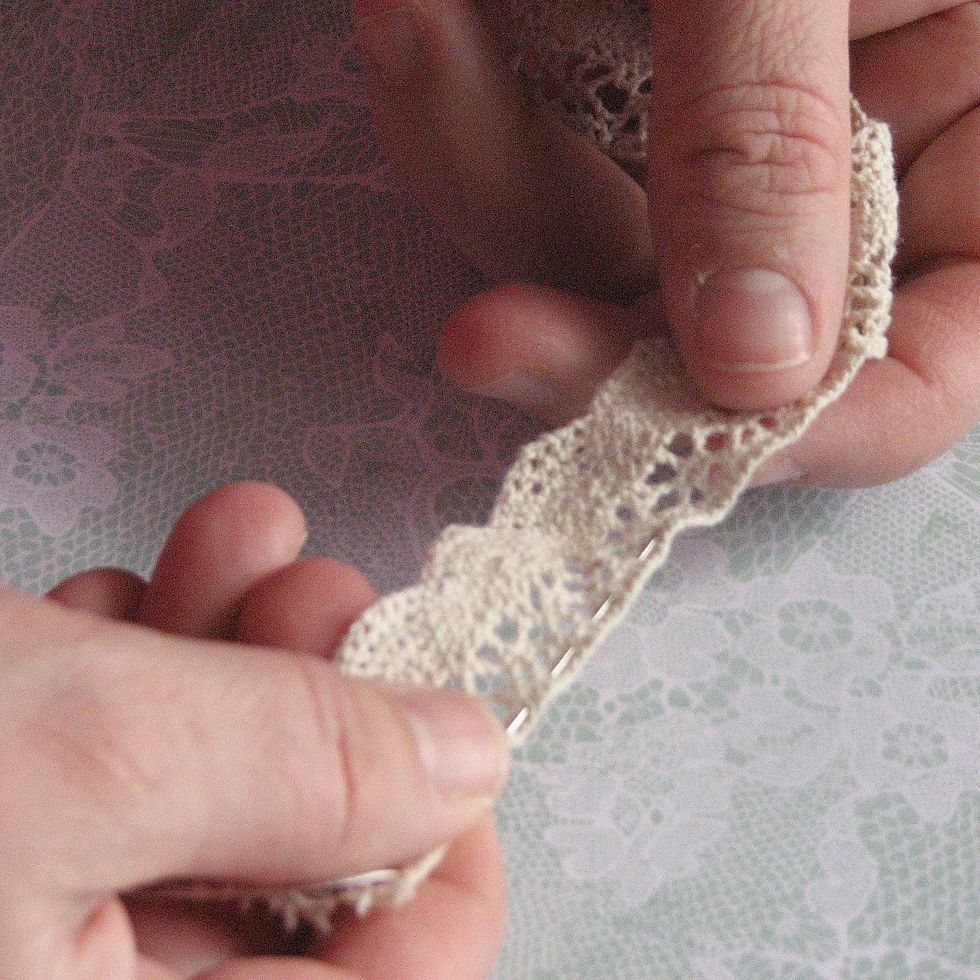 Thread your needle and complete a running stitch or a straight stitch across the length of the lace.