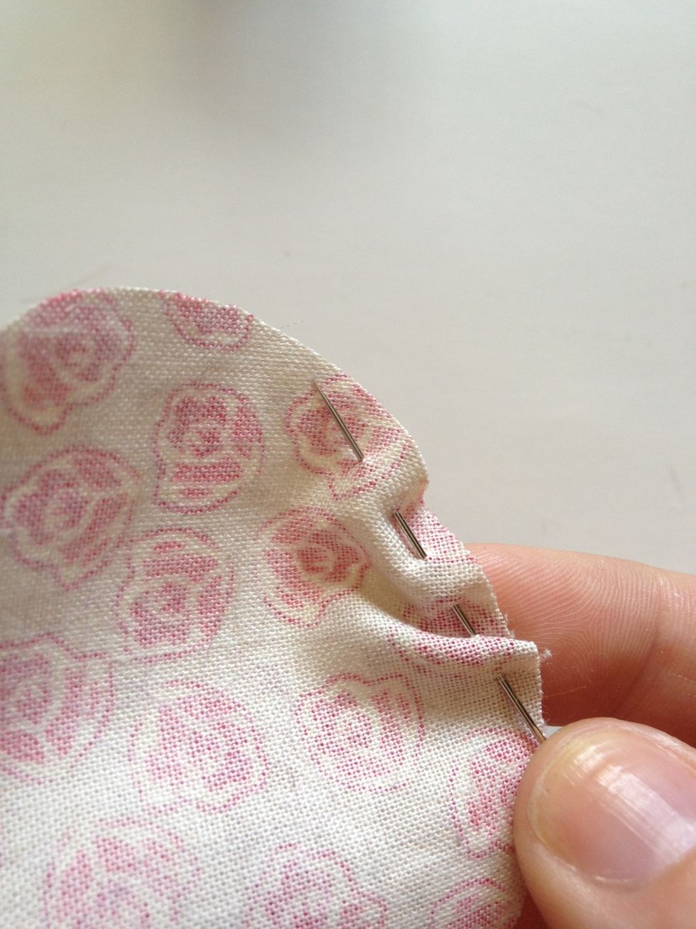 Thread your needle and tie a knot. Use a basting stitch (small stitches from the back of the fabric to the front and back again) all the way around the edge of your circle.