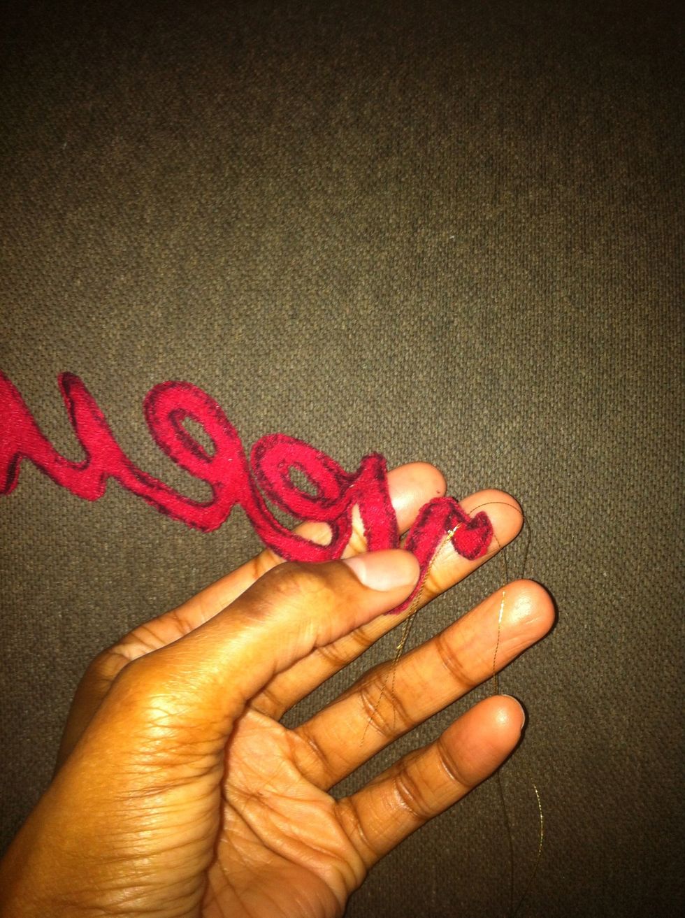 Thread your needle, double knot it, then insert it into the backside of your appliqu\u00e9. This way the thread ends won't be exposed later as they'll end up sandwiched between two layers of fabric.