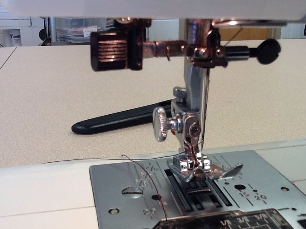 Thread your needle from front to back pulling around 4" of thread behind.