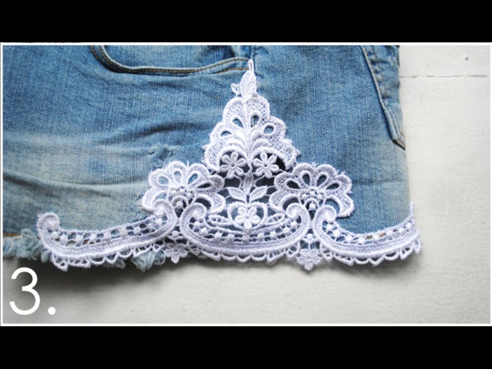 Thread your needle, tie a knot at the end of the thread, and start sewing the lace to your shorts, pulling the needle in and out. Make sure you sew both the inner and outer edges.