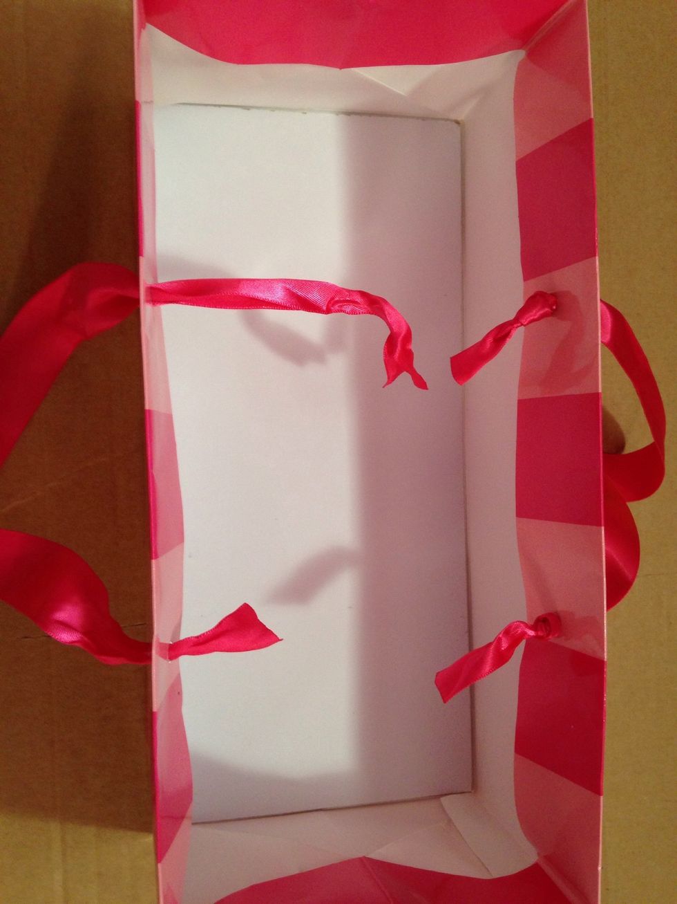 Thread your ribbon handles through the holes & retie the knots.