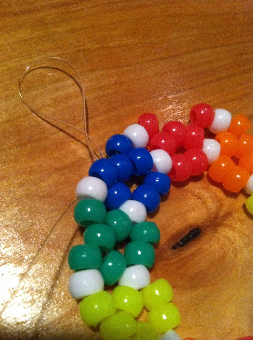 Thread your string through the blue beads and white.
