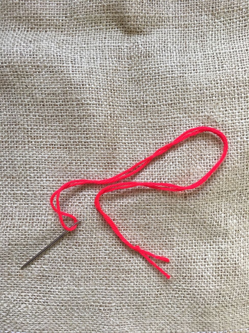 Threaded needle and fabric.