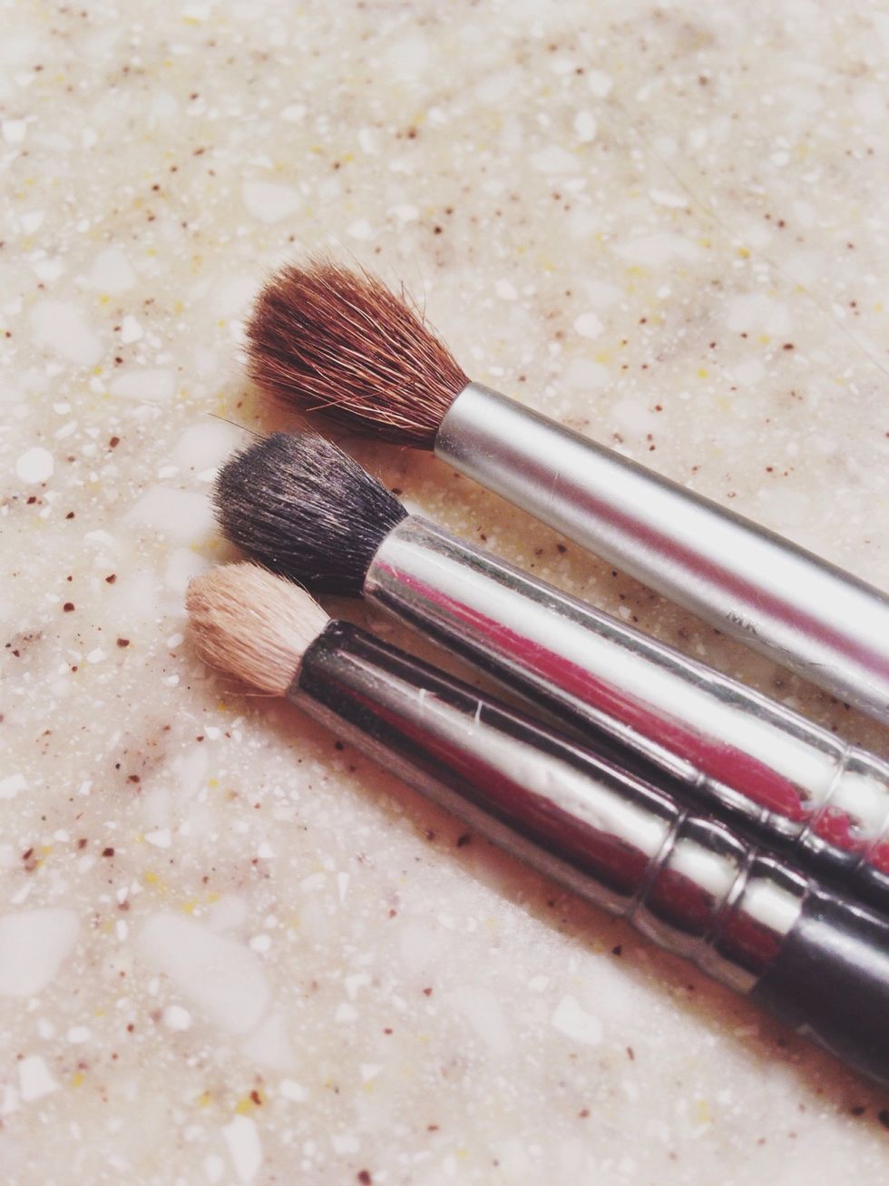 Three brushes for three areas. The white brush is used for highlighting your brow one and the inner corner of your eye. That's where we will begin.