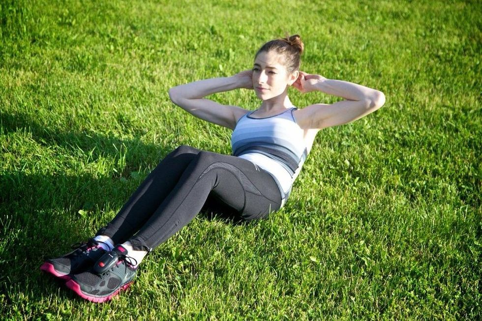 THREE WAY CRUNCHES: Contract your abdominal muscles so you are being lifted off the ground by your abdominal strength alone. Hold this position, then return to starting.
