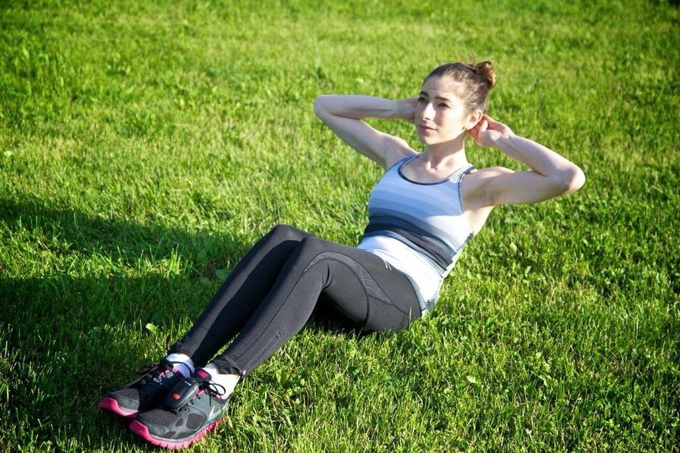 THREE WAY CRUNCHES: Lay on your back with legs bent and feet on the floor. Place hands under your neck and lift off the ground so nothing above your shoulder blades is touching the ground.