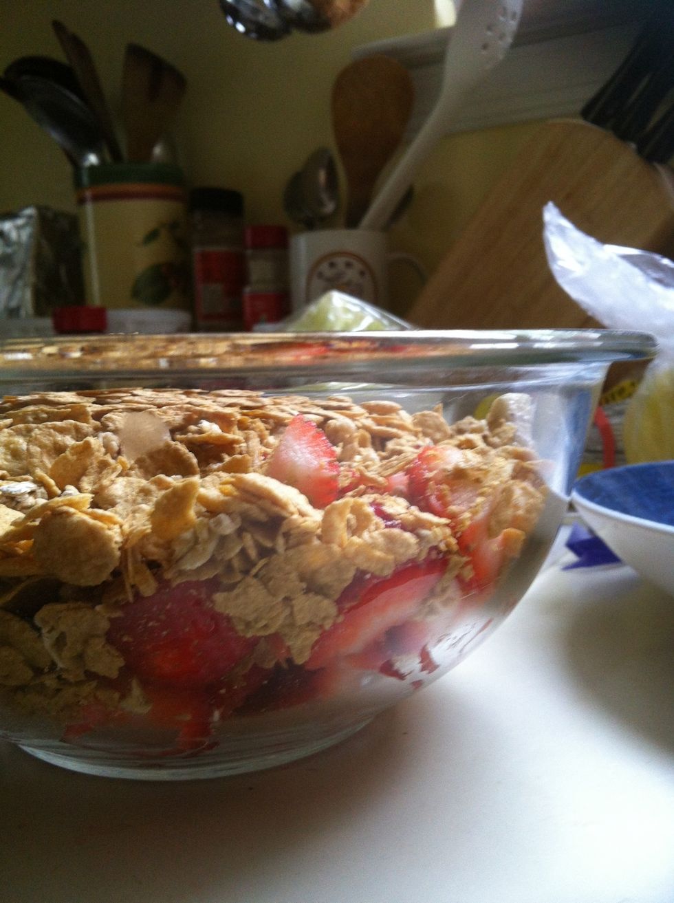 Throw all your ingredients: banana, strawberries and cereal into a big bowl (any kind of berries would go good with this too) sorry for lack of supplies, this was last minute!