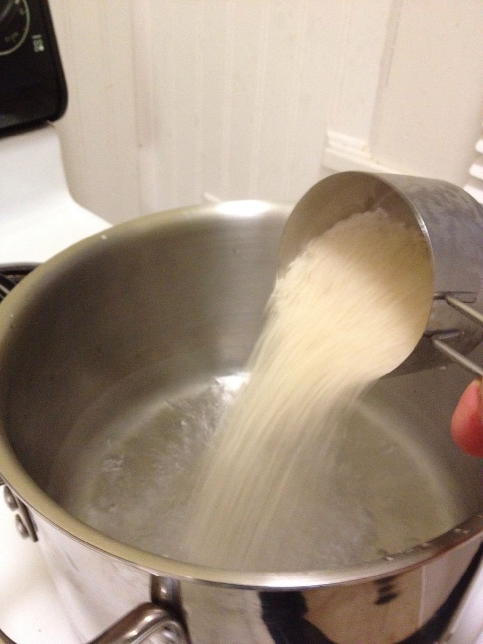 Throw at least a cup of rice in the boiling water with a couple generous pinches of salt. Boil for 6-8 min. Stir it a couple of times. (use more if you have/want friends)